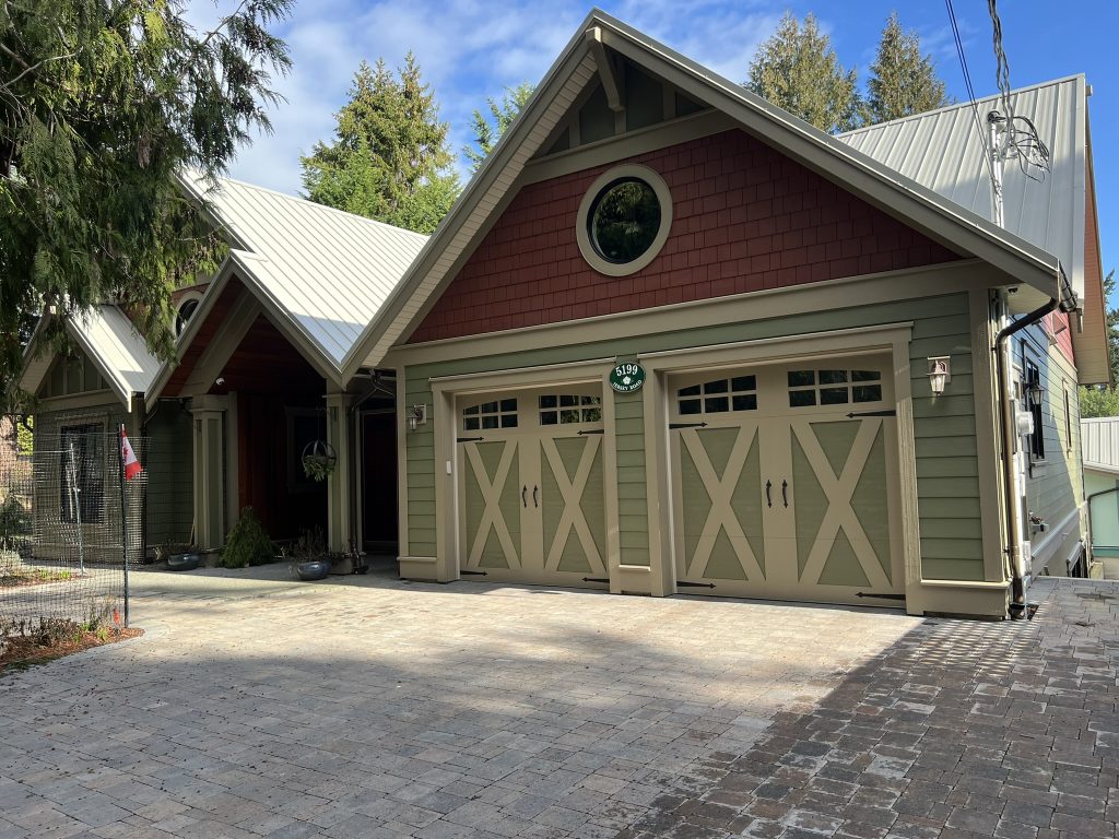 An exterior of a house with red and green siding and taupe trim.